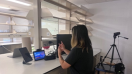 a person standing in front of the screen while signing